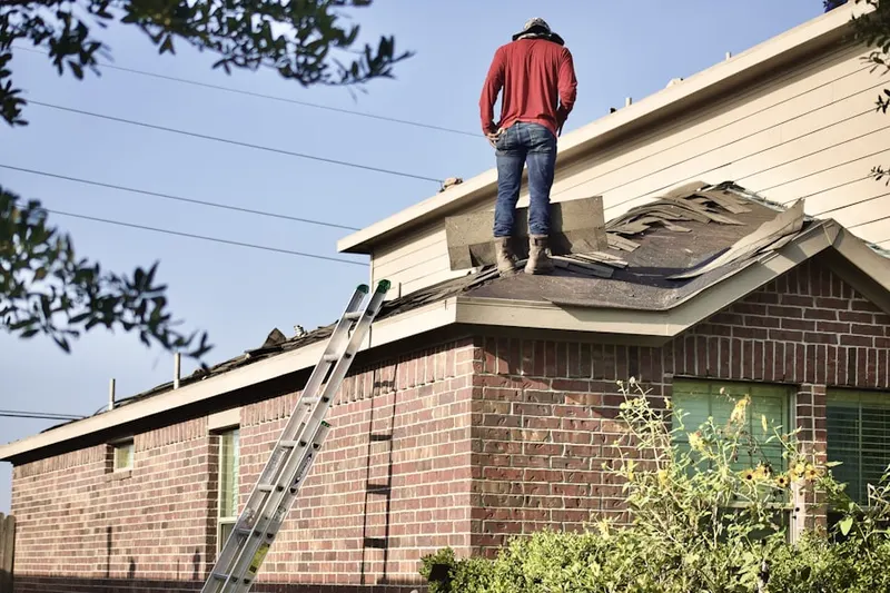 Professional roofer working on a residential roof in Quincy
